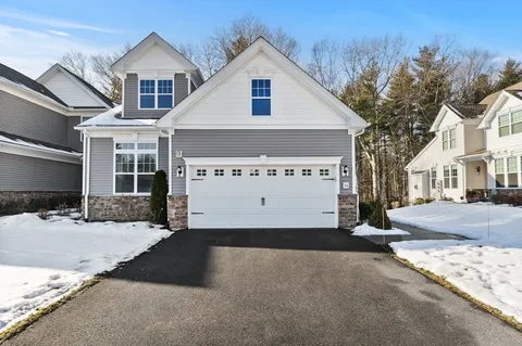 a view of a house with large windows and a table and chairs