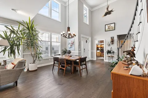 a dining room with furniture and wooden floor