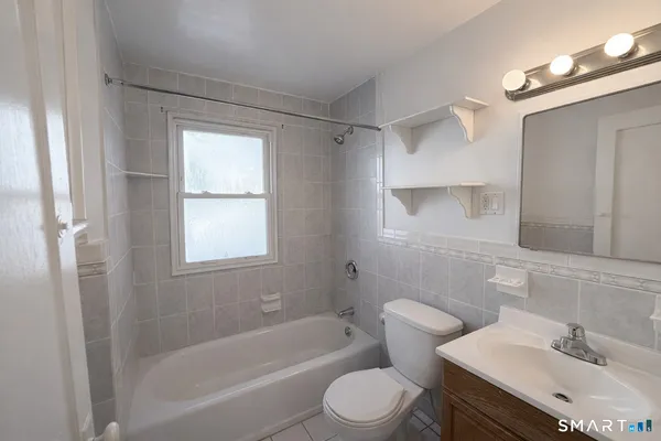 a bathroom with a sink toilet bathtub and vanity