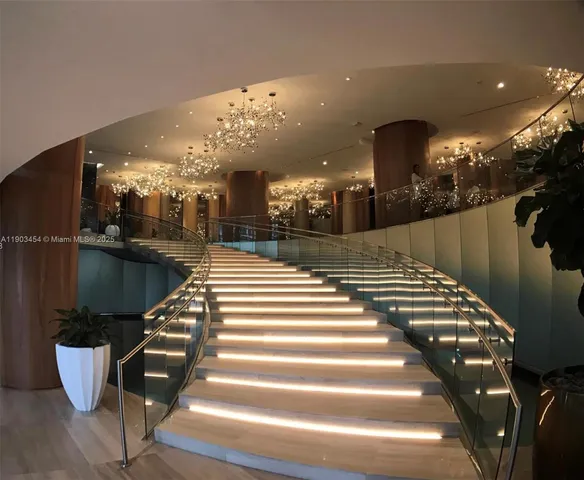 a lobby with furniture and a chandelier