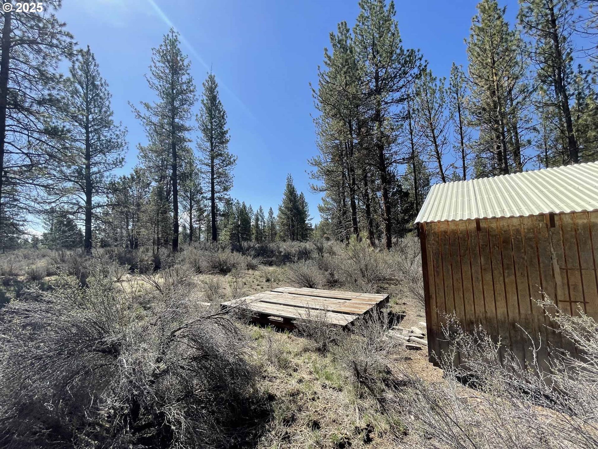 44 Off Nf Road, Unit 1600 Chiloquin, OR 97624 - Photo 29 of 33 a view of a backyard with wooden fence and trees