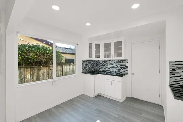 a view of kitchen with furniture and wooden floor