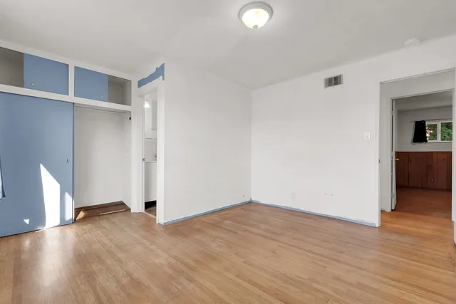 an empty room with wooden floor