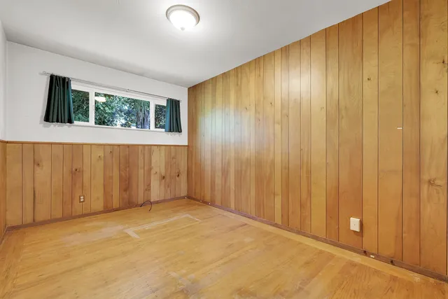 an empty room with wooden walls