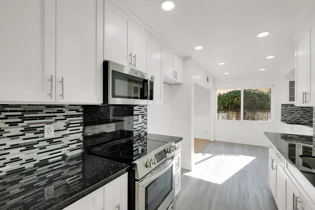 a kitchen with sink and cabinets
