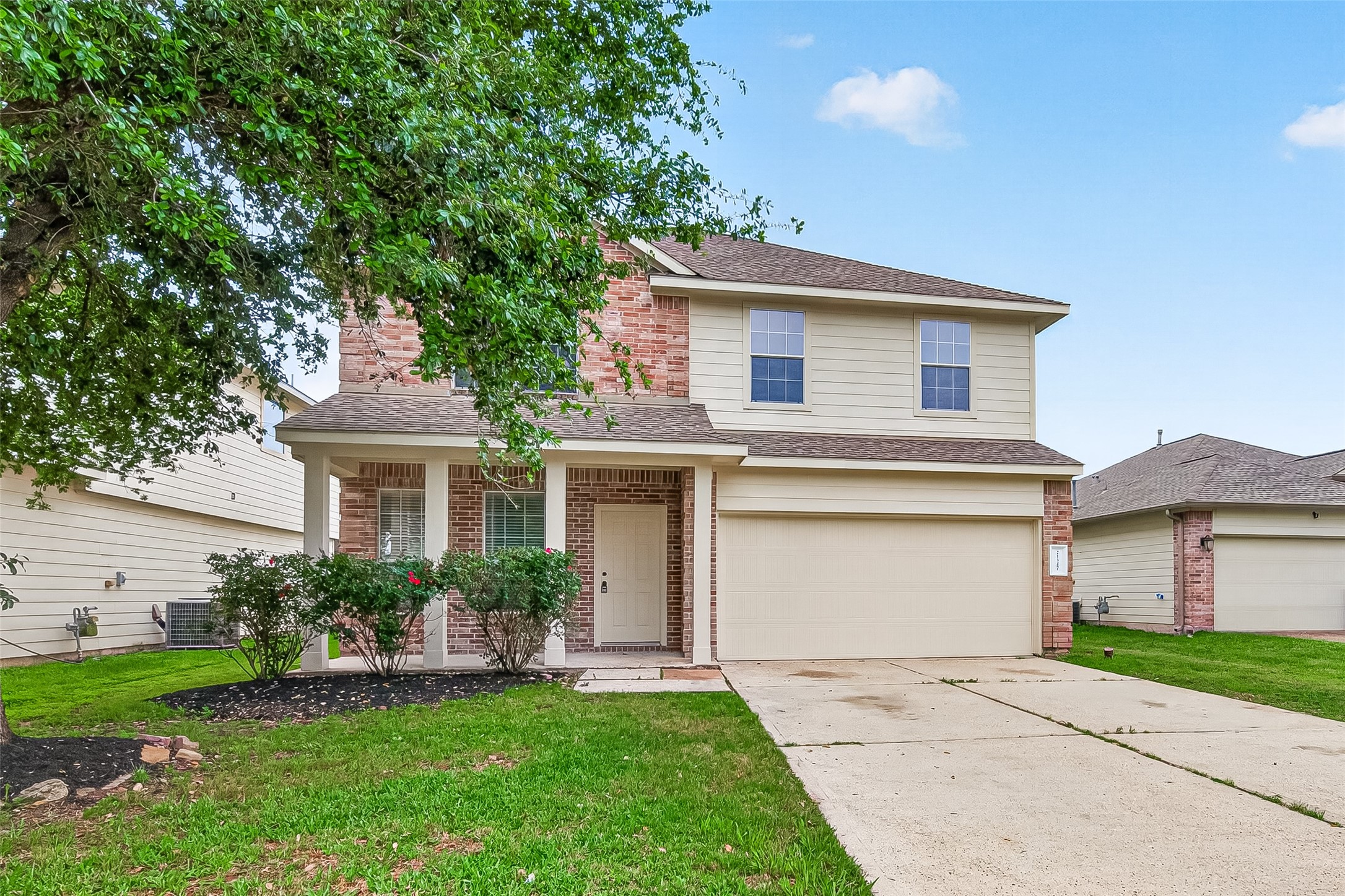 21327 Bella Flora Court Spring, TX 77379 - Photo 3 of 50 a front view of a house with a garden and plants