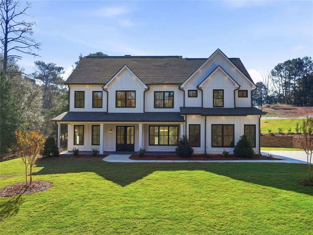 a front view of a house with yard and green space