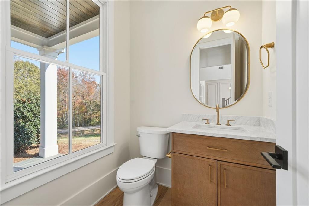 420 Stock Gap Road Southwest Monroe, GA 30656 - Photo 18 of 50 a bathroom with a toilet sink and mirror