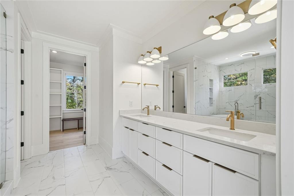 420 Stock Gap Road Southwest Monroe, GA 30656 - Photo 22 of 50 a spacious bathroom with a granite countertop sink a toilet and a mirror