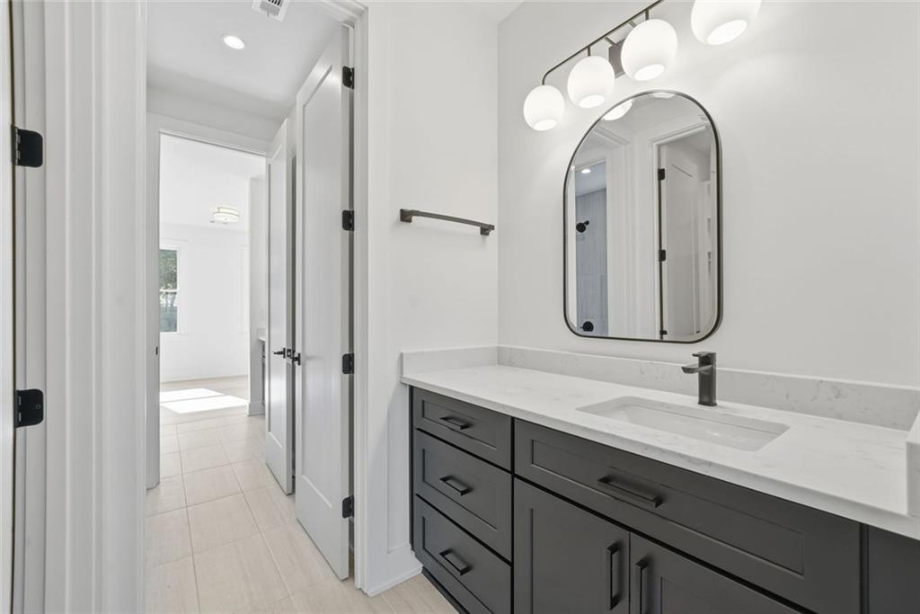 420 Stock Gap Road Southwest Monroe, GA 30656 - Photo 34 of 50 a bathroom with a double vanity sink mirror and