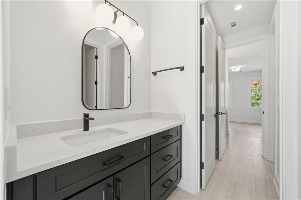 420 Stock Gap Road Southwest Monroe, GA 30656 - Photo 36 of 50 a bathroom with a double vanity sink mirror and