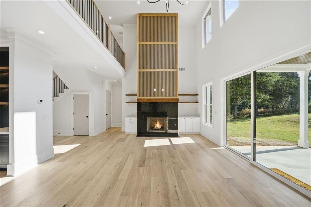 420 Stock Gap Road Southwest Monroe, GA 30656 - Photo 7 of 50 a view of an empty room with wooden floor fireplace and a window