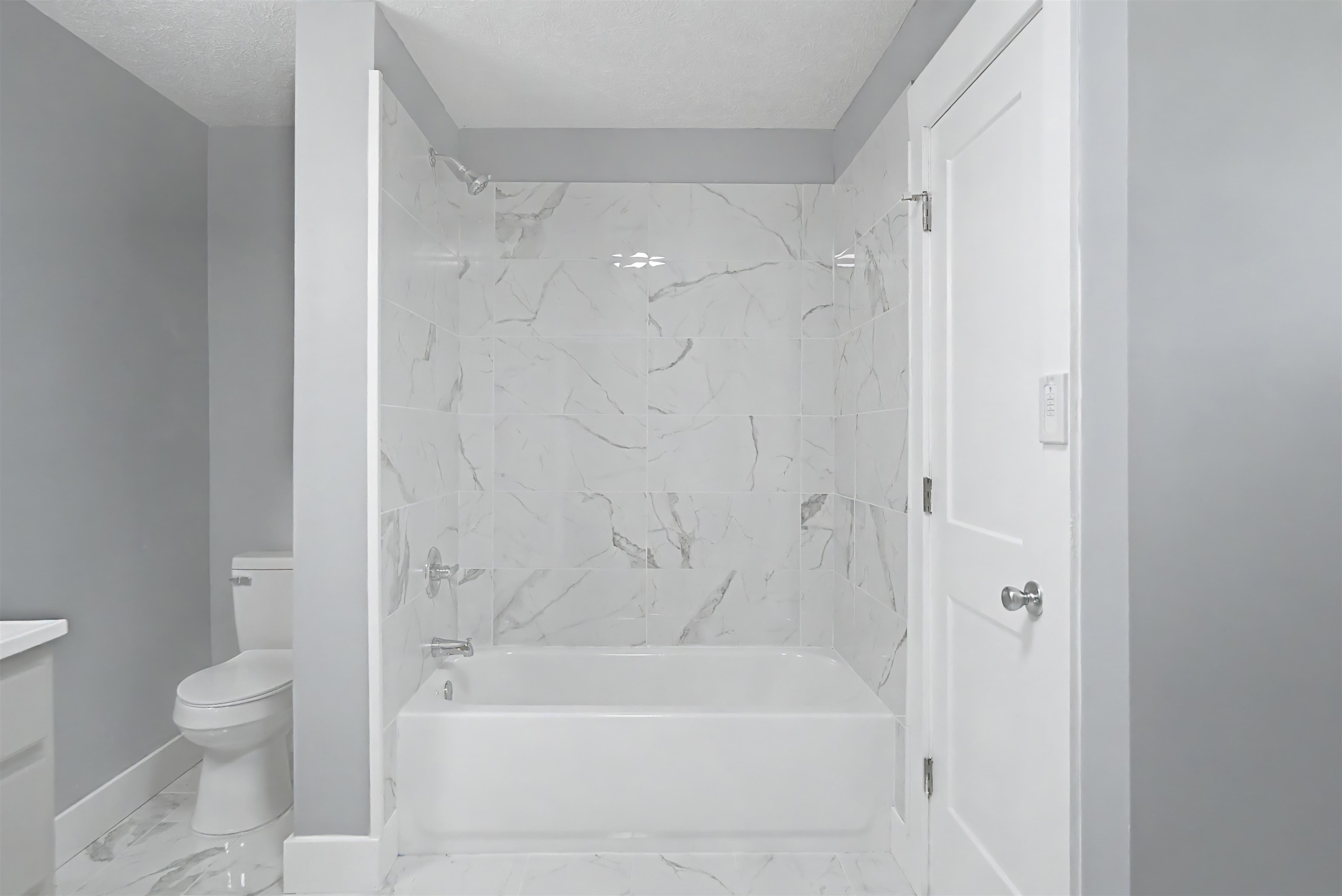7437 Highway 45 Ramer, TN 38367 - Photo 23 of 36 Full bathtub with polished chrome fixtures, white subway tile surround, and a white toilet