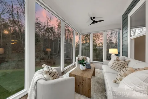 a living room with furniture and a floor to ceiling window