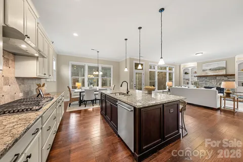 a kitchen with sink stove and cabinets