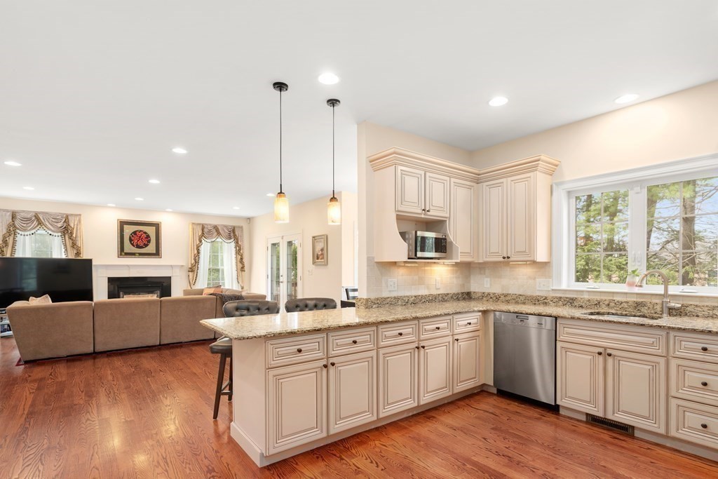 11 Shadow Lane Wellesley, MA 02482 - Photo 13 of 37 a kitchen with granite countertop white cabinets and white appliances
