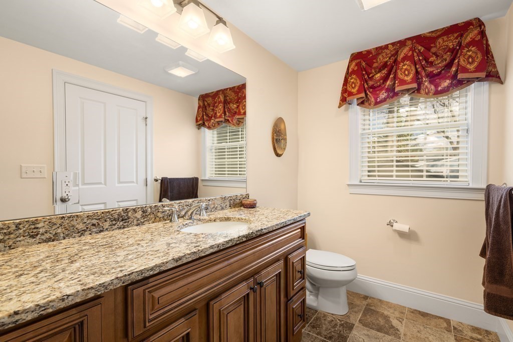 11 Shadow Lane Wellesley, MA 02482 - Photo 14 of 37 a bathroom with a granite countertop toilet a sink and a window