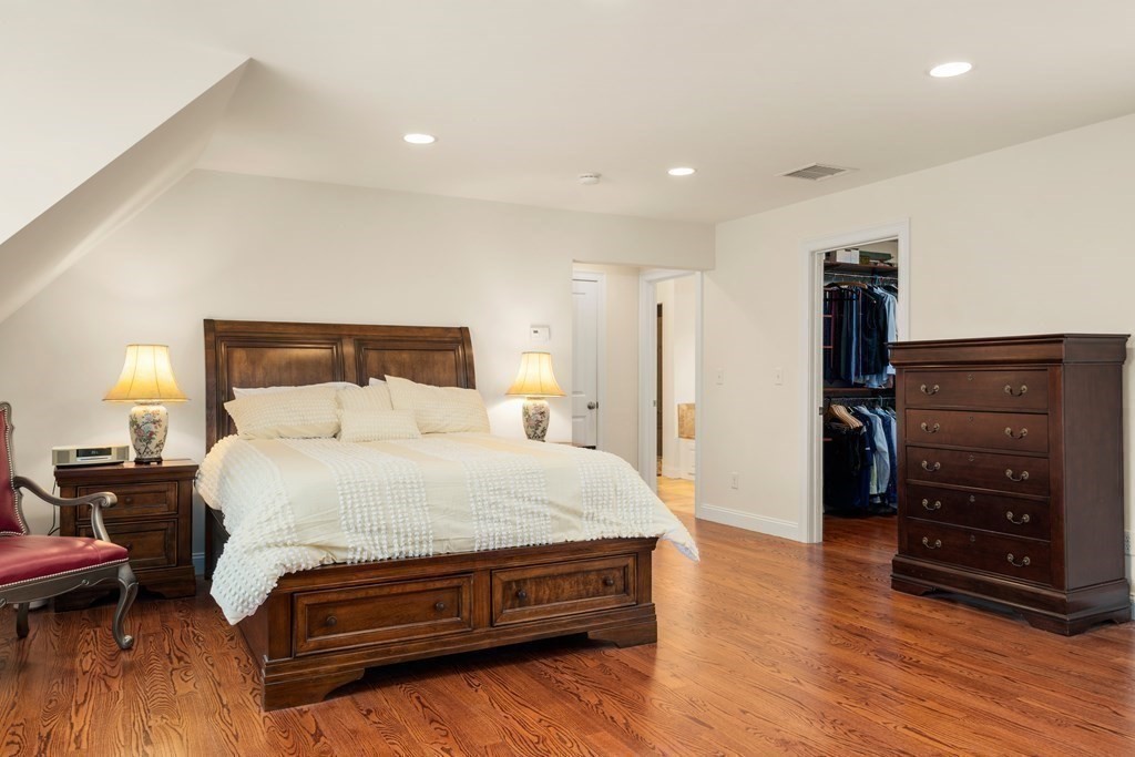 11 Shadow Lane Wellesley, MA 02482 - Photo 17 of 37 a spacious bedroom with a bed and wooden floor