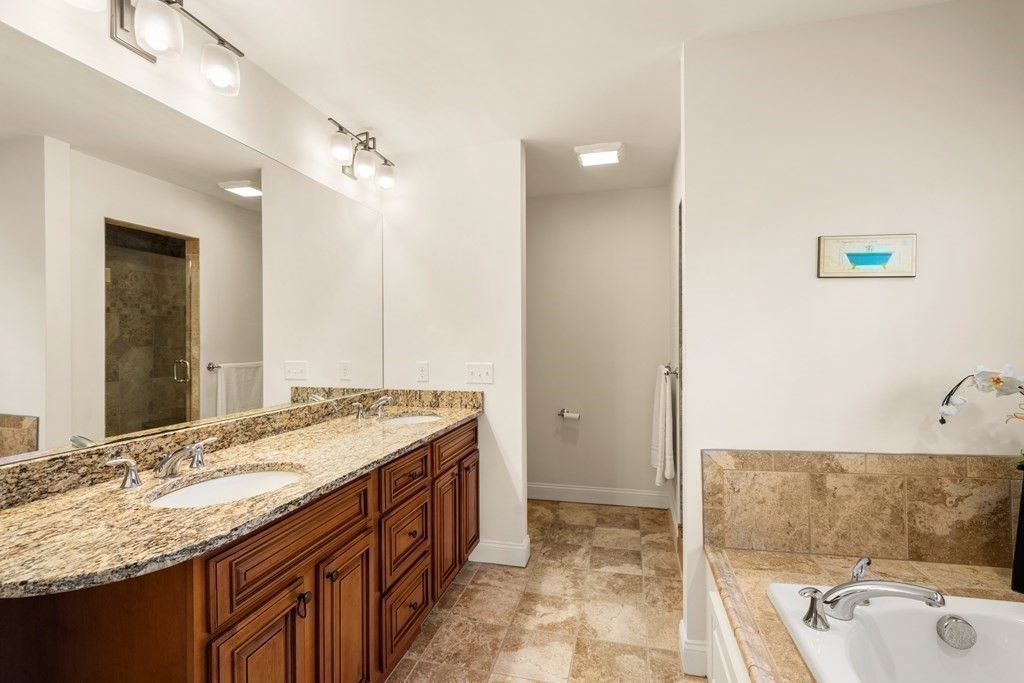 11 Shadow Lane Wellesley, MA 02482 - Photo 19 of 37 a bathroom with a granite countertop tub sink and mirror