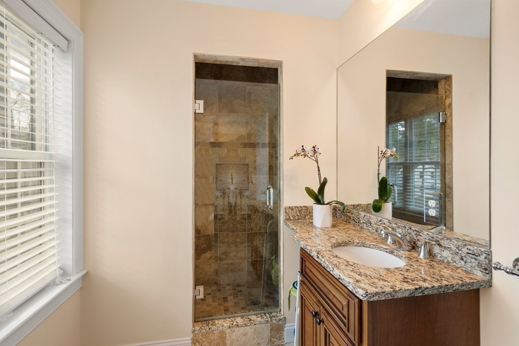 11 Shadow Lane Wellesley, MA 02482 - Photo 22 of 37 a bathroom with a granite countertop sink and a mirror