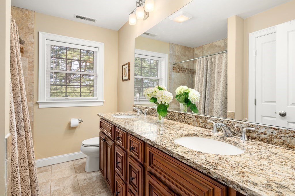 11 Shadow Lane Wellesley, MA 02482 - Photo 24 of 37 a bathroom with a granite countertop sink and a mirror