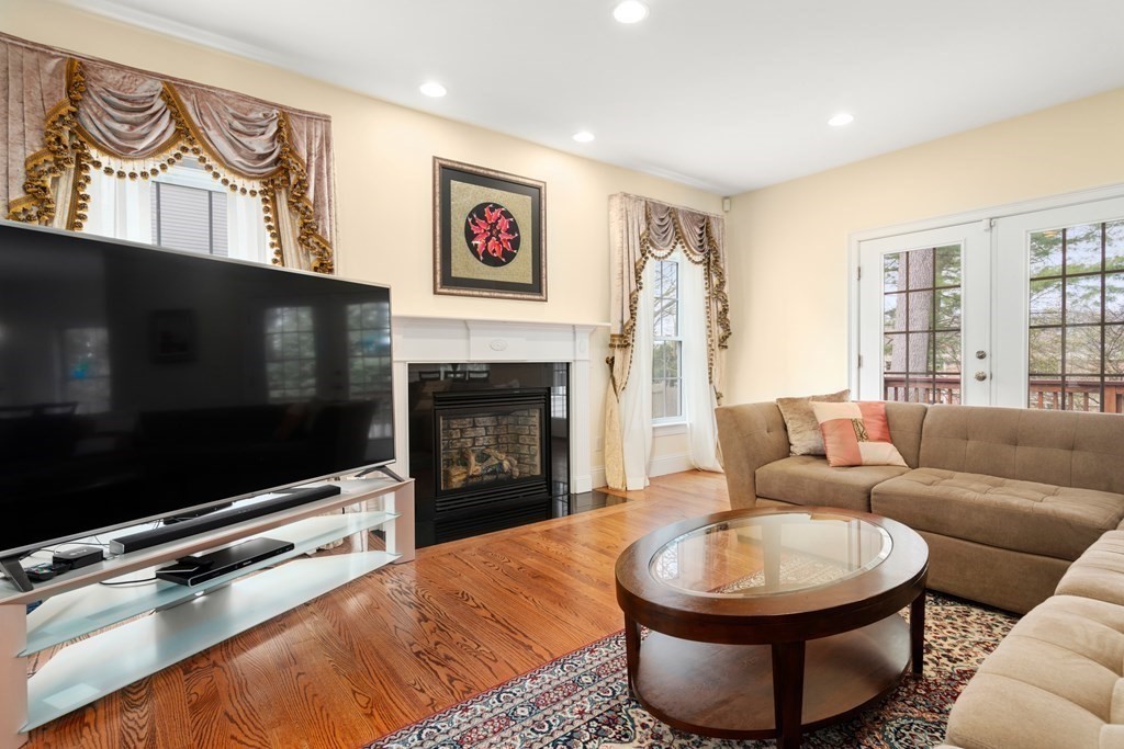 11 Shadow Lane Wellesley, MA 02482 - Photo 7 of 37 a living room with furniture a flat screen tv and a fireplace