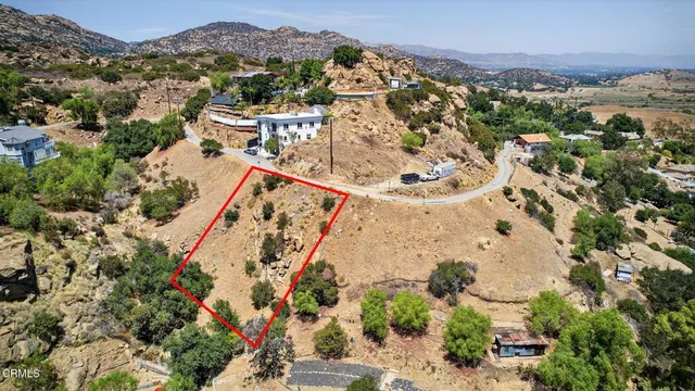 an aerial view of a house with a mountain