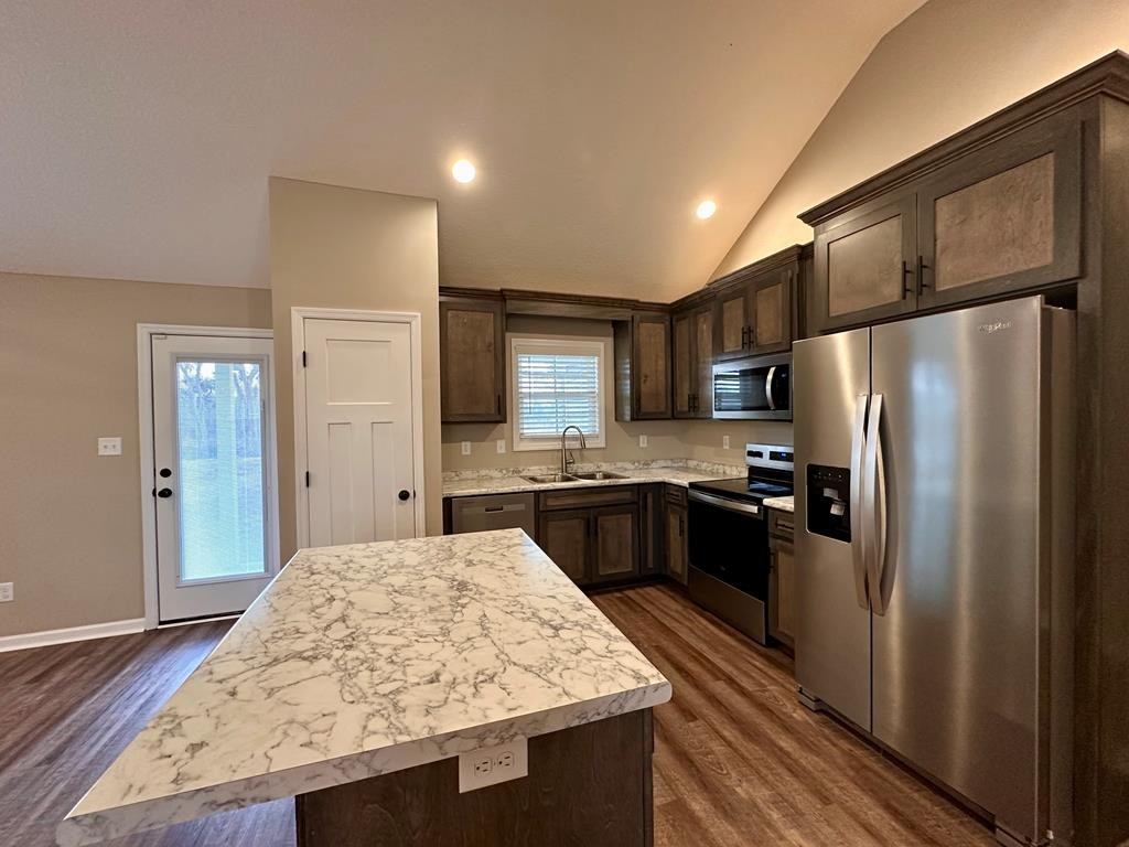4603 Brees Way Valdosta, GA 31601 - Photo 4 of 31 a kitchen with stainless steel appliances granite countertop refrigerator sink and cabinets