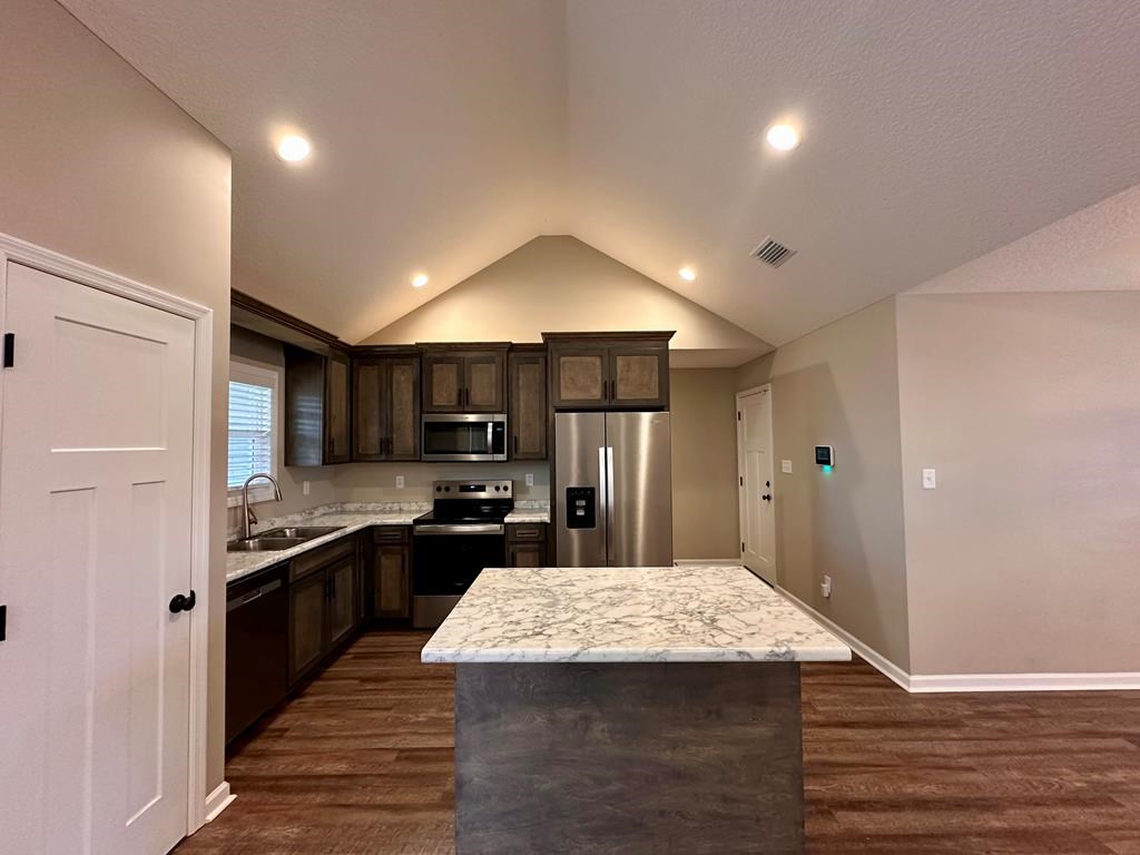 4603 Brees Way Valdosta, GA 31601 - Photo 5 of 31 a kitchen with kitchen island a sink stove and refrigerator