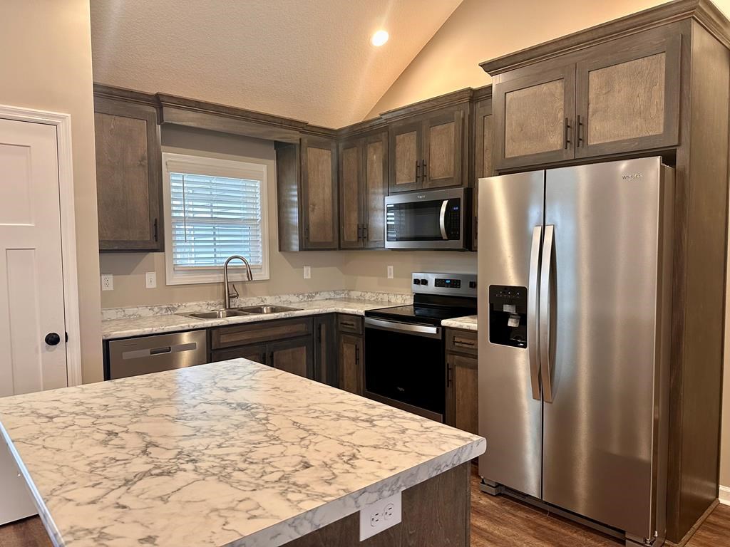 4603 Brees Way Valdosta, GA 31601 - Photo 6 of 31 a kitchen with stainless steel appliances granite countertop a refrigerator sink stove microwave and cabinets