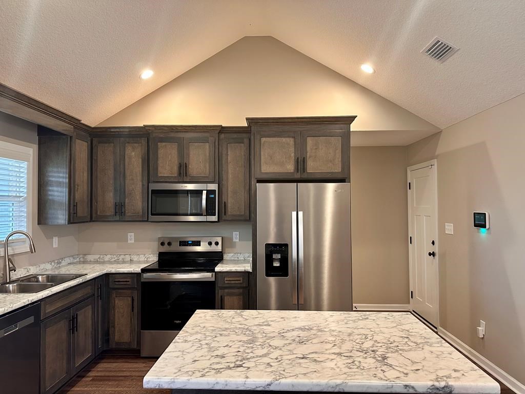 4603 Brees Way Valdosta, GA 31601 - Photo 7 of 31 a kitchen with stainless steel appliances granite countertop a refrigerator stove top oven and sink