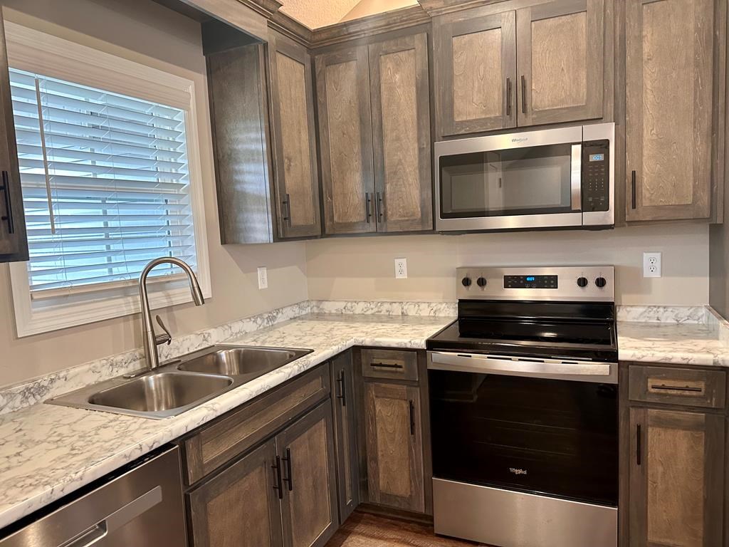 4603 Brees Way Valdosta, GA 31601 - Photo 8 of 31 a kitchen with granite countertop a sink cabinets and stainless steel appliances