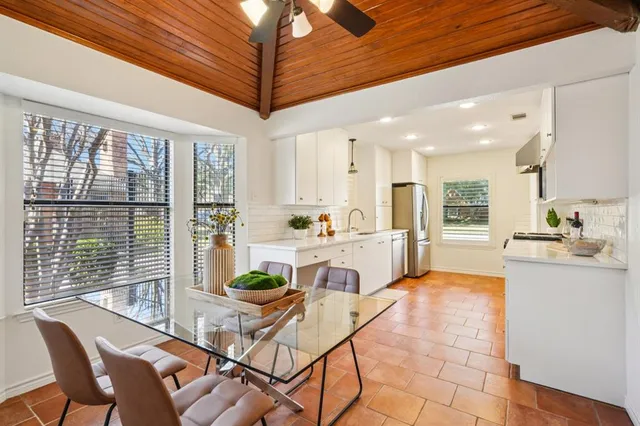 a room with stainless steel appliances kitchen island granite countertop furniture and a view of kitchen