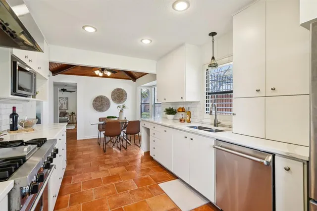 a kitchen with a sink appliances and cabinets