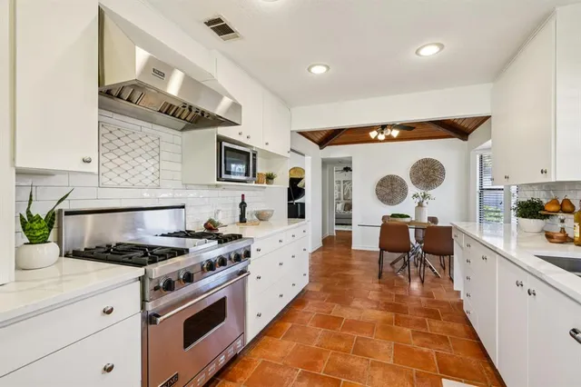 a kitchen with a stove and a white refrigerator