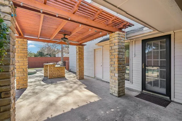 a view of a porch with a table and chairs