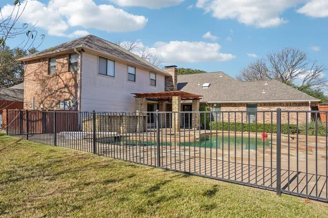 a view of a house with a wooden fence