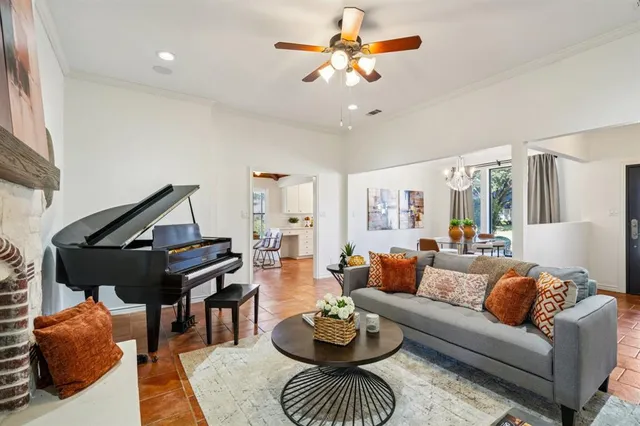 a living room with furniture a rug and a chandelier