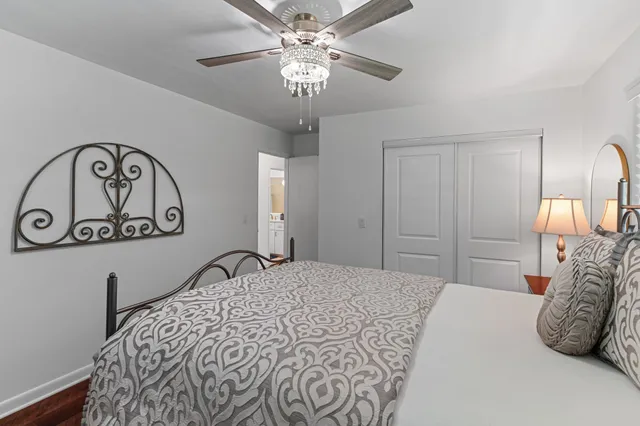 a spacious bathroom with a toilet a sink and a mirror