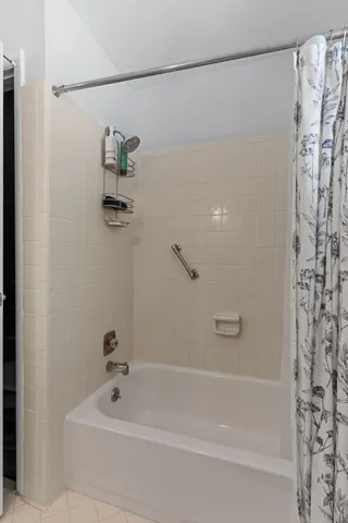 a living room with furniture a flat screen tv and a large window