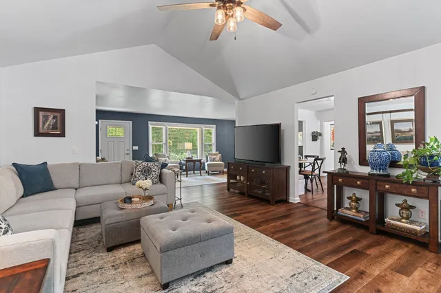 a view of a dining room with furniture and wooden floor