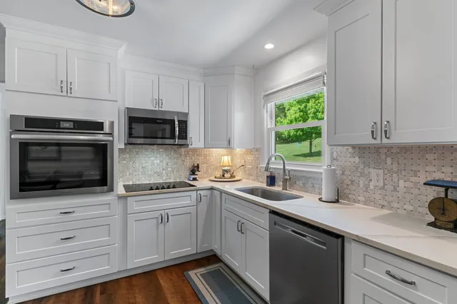 a bedroom with a bed and a flat tv screen on dresser
