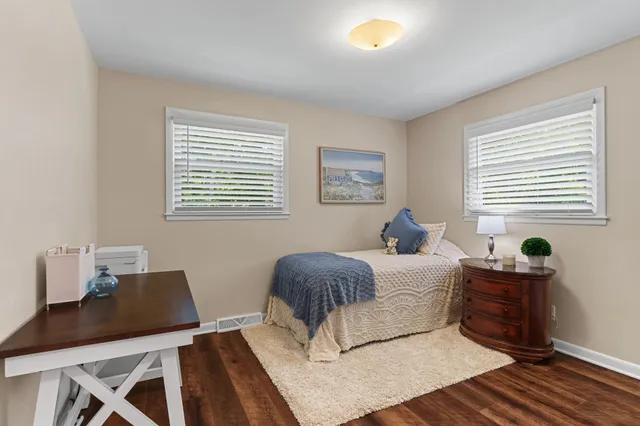 a bedroom with a large bed and a chandelier