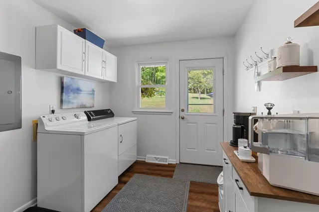a living room with furniture rug and window