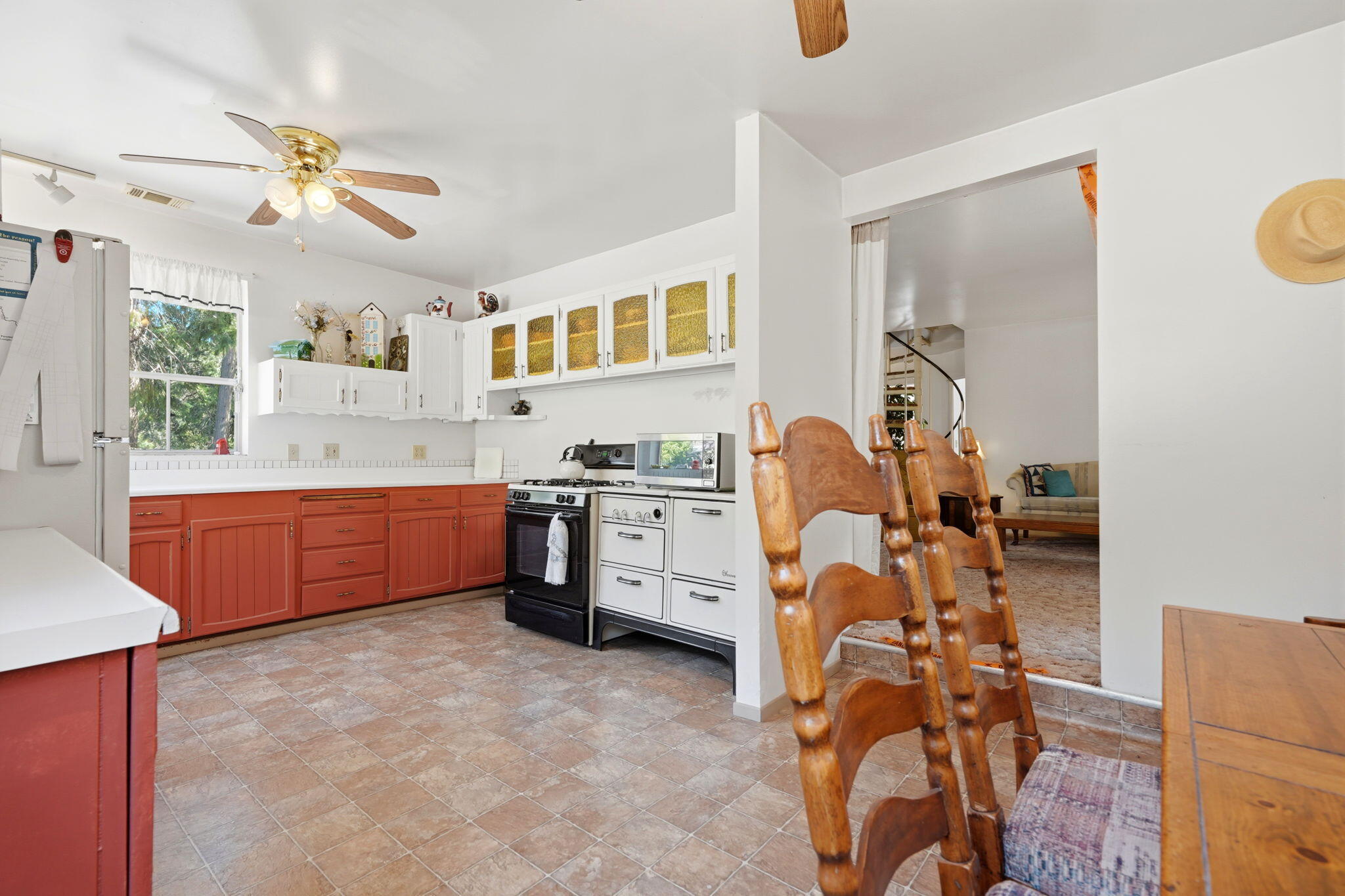 697 Loop Drive Springville, CA 93265 - Photo 17 of 55 a large white kitchen with a stove a sink dishwasher and a fireplace with wooden floor