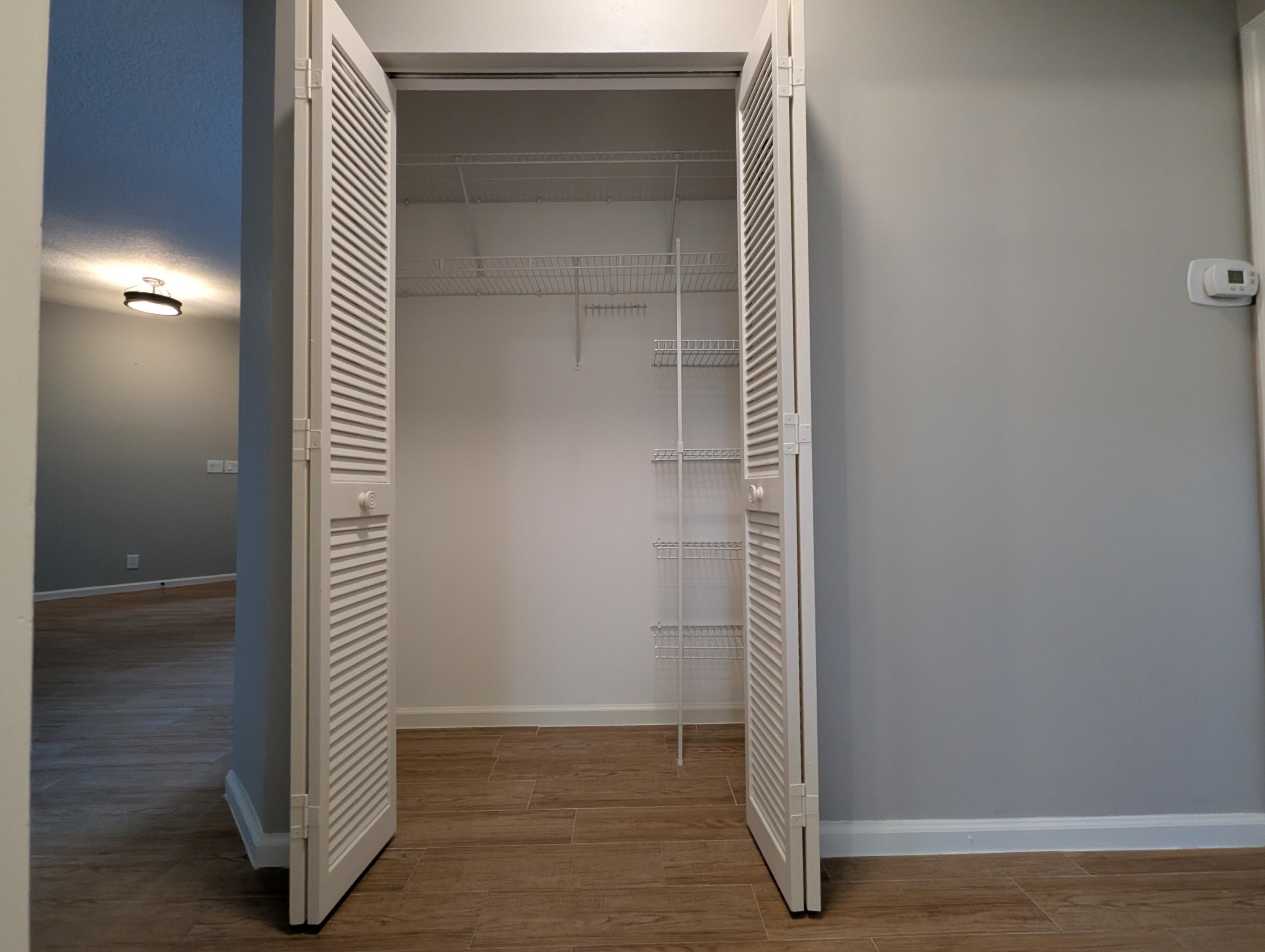 175 Harbor Lake Circle Greenacres, FL 33413 - Photo 16 of 33 an empty room with wooden floor