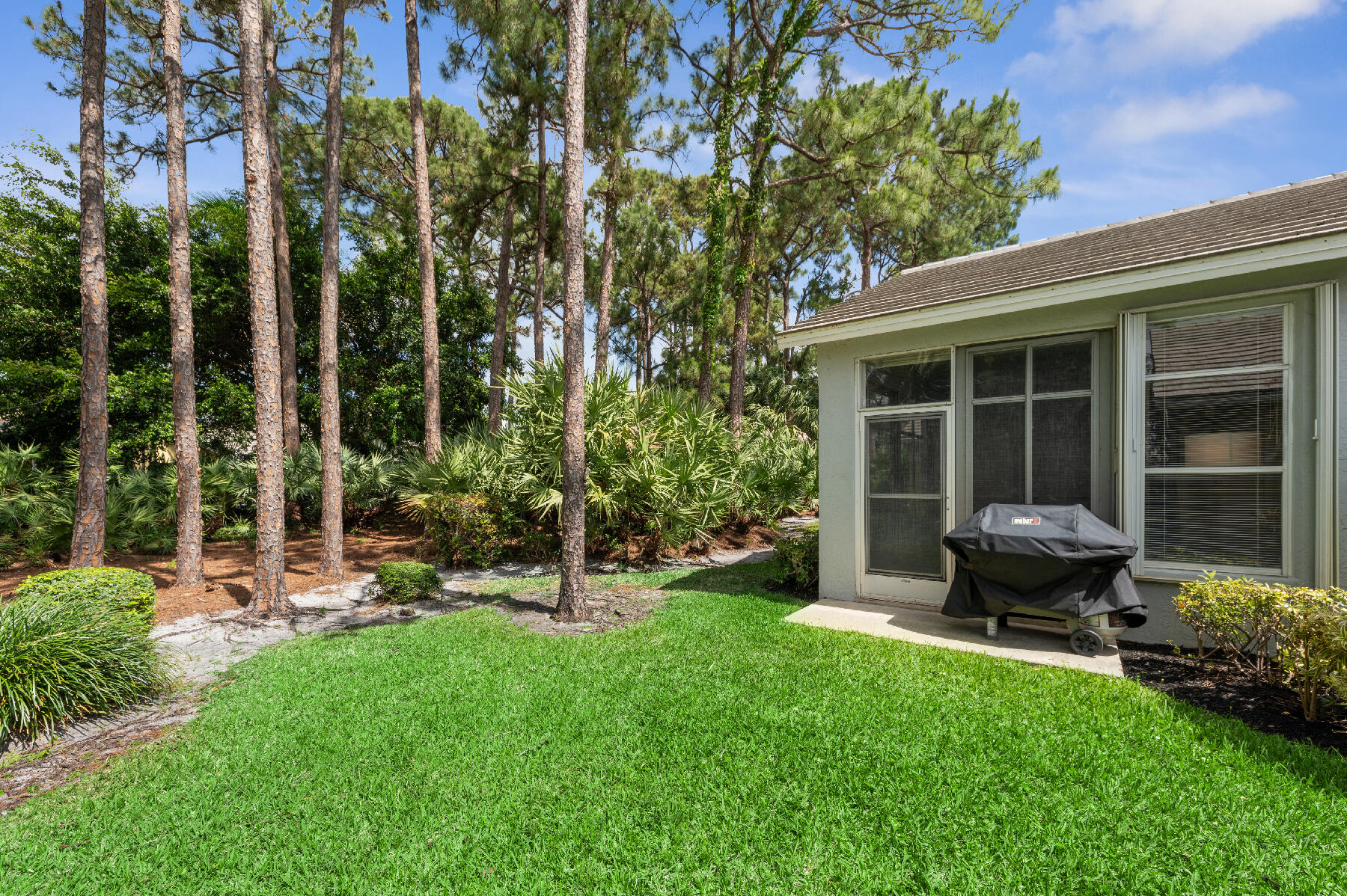 175 Harbor Lake Circle Greenacres, FL 33413 - Photo 20 of 33 a view of a backyard with sitting area and garden