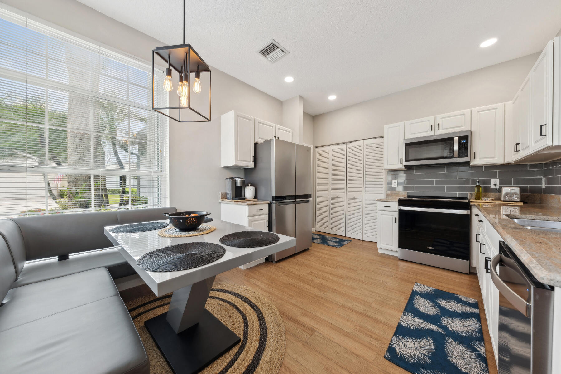 175 Harbor Lake Circle Greenacres, FL 33413 - Photo 4 of 33 a kitchen with sink refrigerator and microwave