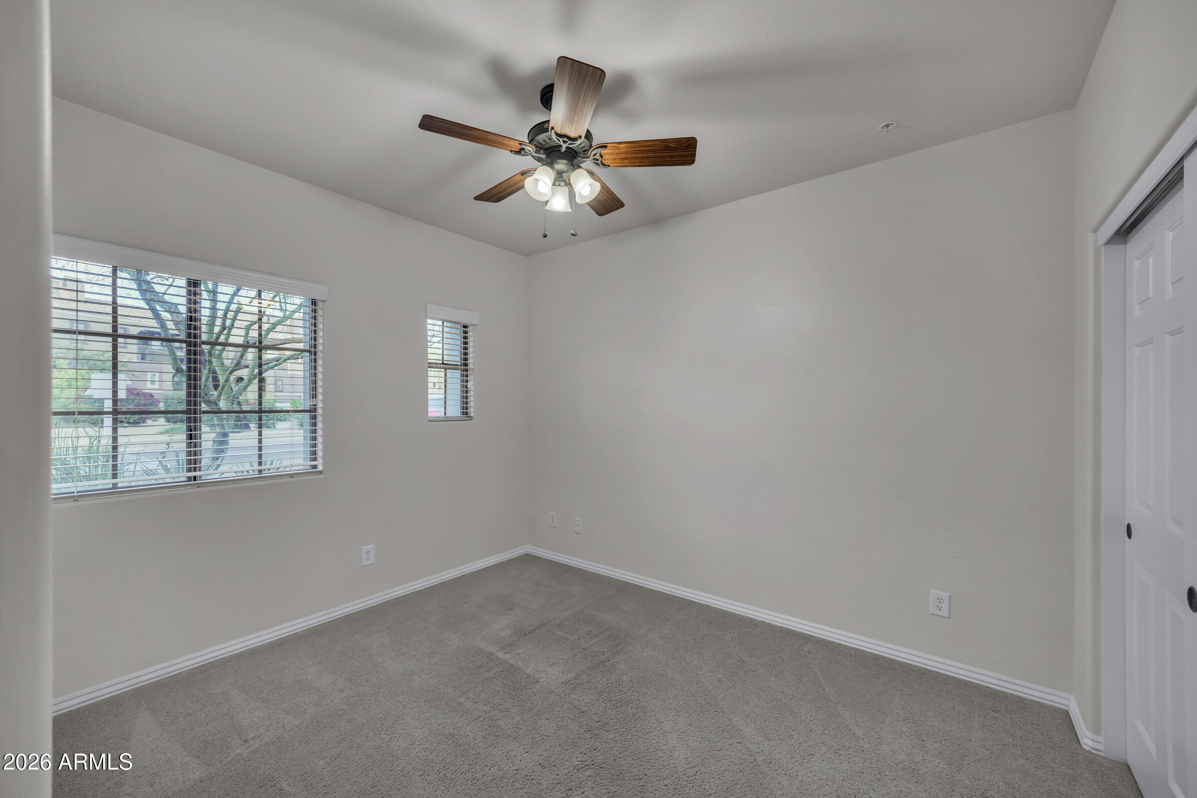 3935 East Rough Rider Road, Unit 1250 Phoenix, AZ 85050 - Photo 16 of 29 an empty room with windows and fan