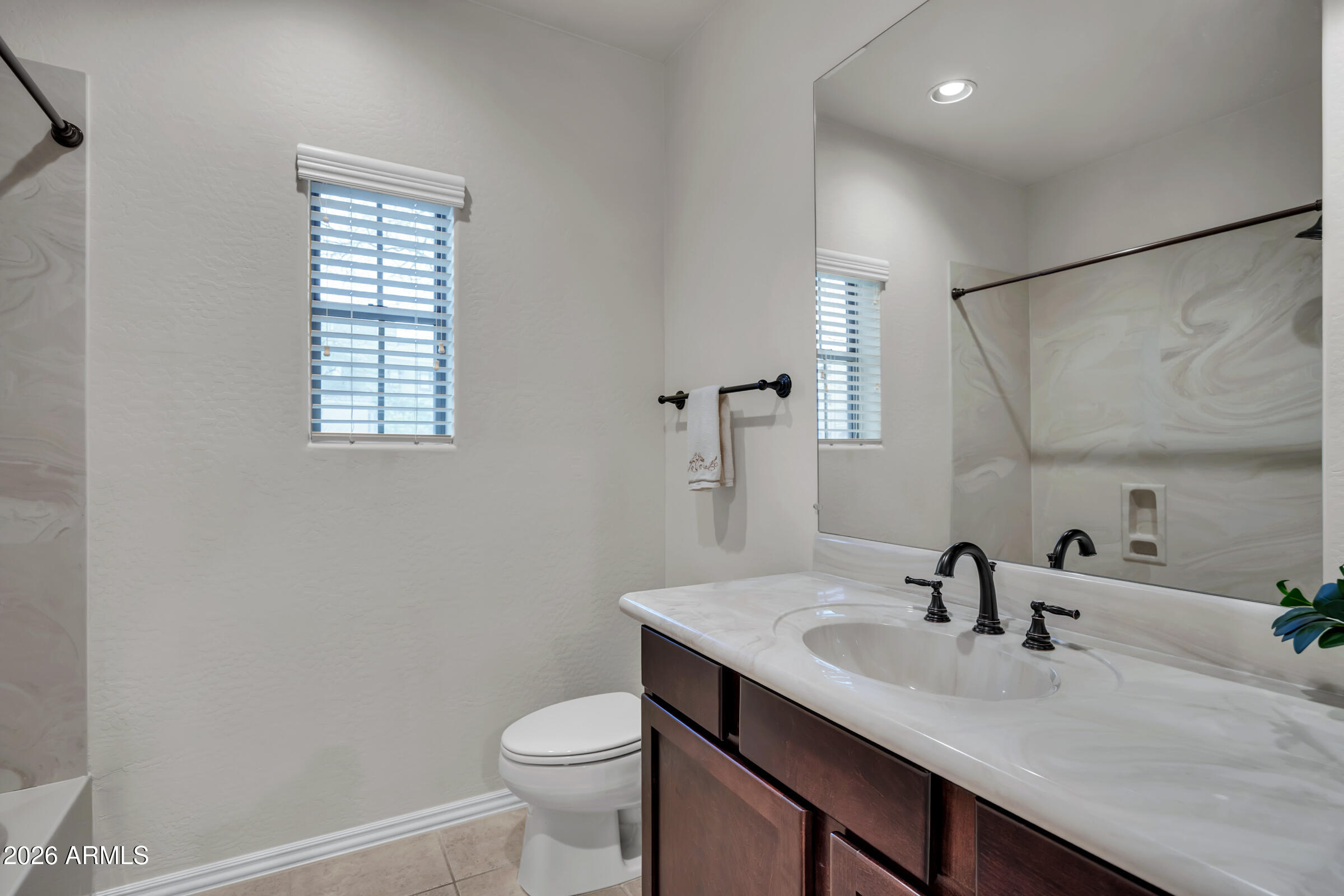 3935 East Rough Rider Road, Unit 1250 Phoenix, AZ 85050 - Photo 17 of 29 a bathroom with a sink and a toilet